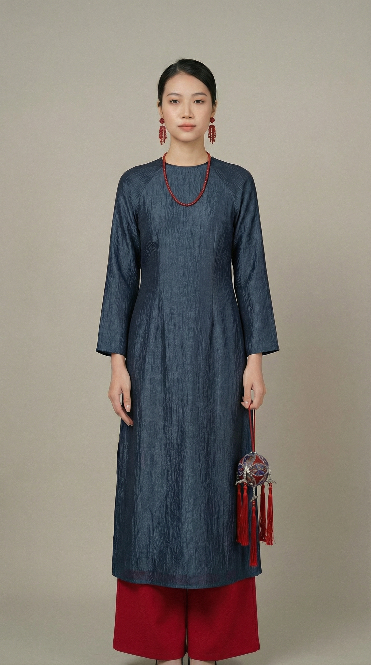 Model wearing the áo dài in a full-body standing pose